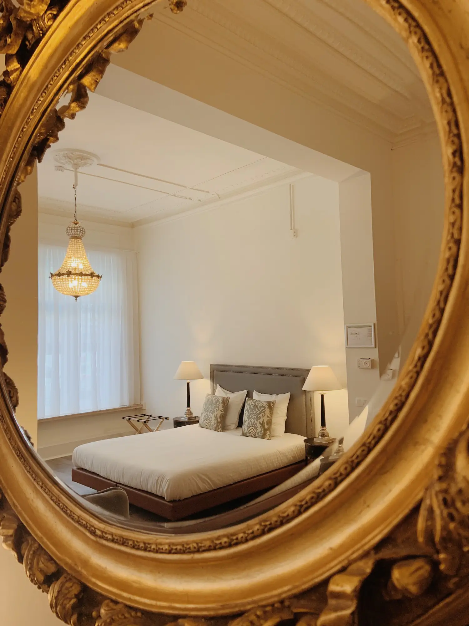 Luxurious junior suite reflected in ornate gilded mirror at La Lys