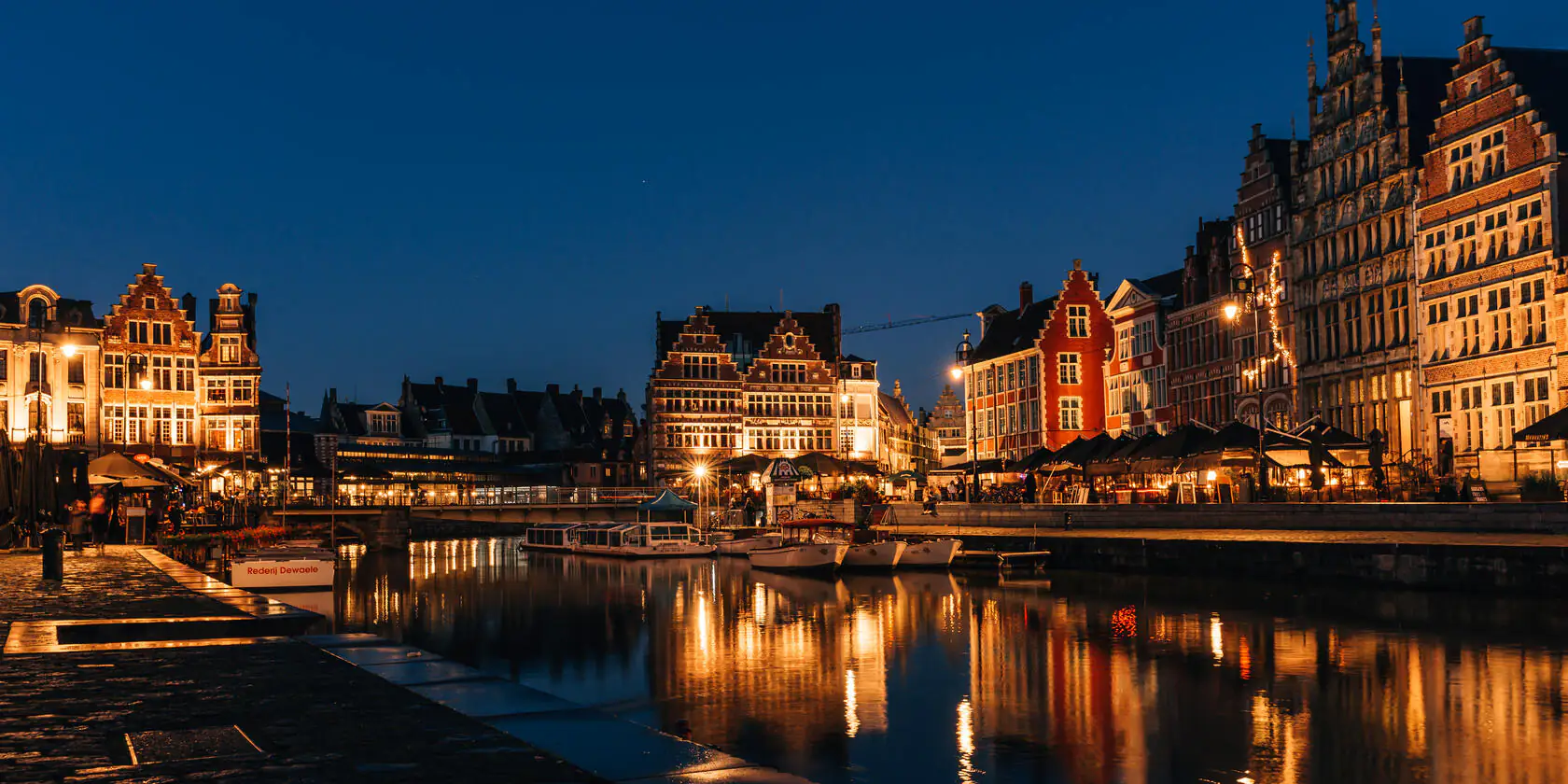Romantic night view of Ghent's historic Graslei along the Leie river