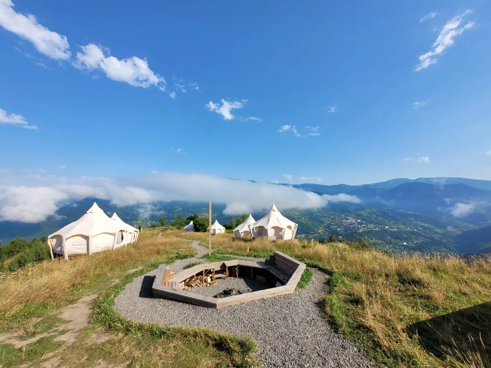 Glamping Tago lotus tents overlooking a mountain ridge covered in mist
